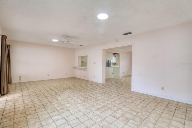 unfurnished room featuring a textured ceiling and ceiling fan