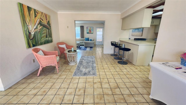 interior space featuring ceiling fan, light countertops, ornamental molding, and light tile patterned flooring