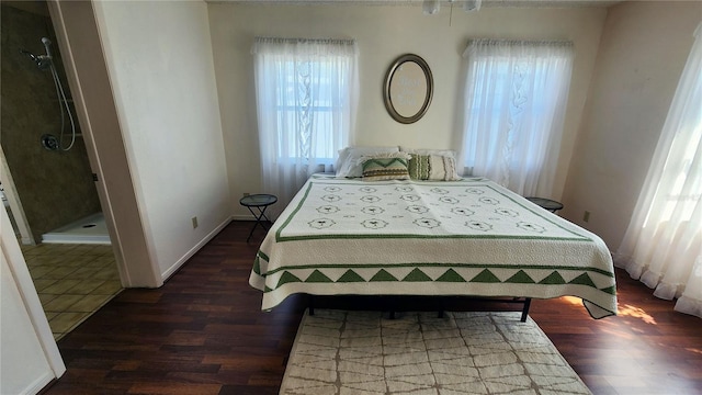 bedroom with baseboards and wood finished floors