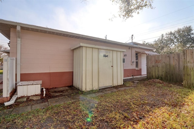 view of outbuilding with fence