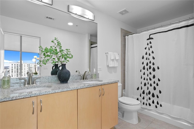 full bathroom with shower / tub combo, vanity, toilet, and tile patterned flooring