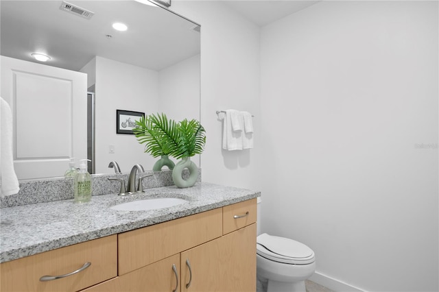 bathroom with vanity, an enclosed shower, and toilet