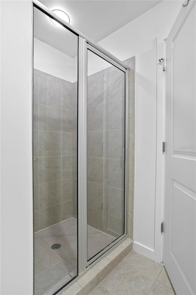 bathroom featuring walk in shower and tile patterned floors