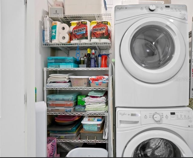 laundry area featuring stacked washer / drying machine