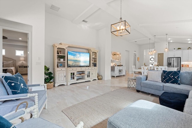 living room with vaulted ceiling with beams and a notable chandelier