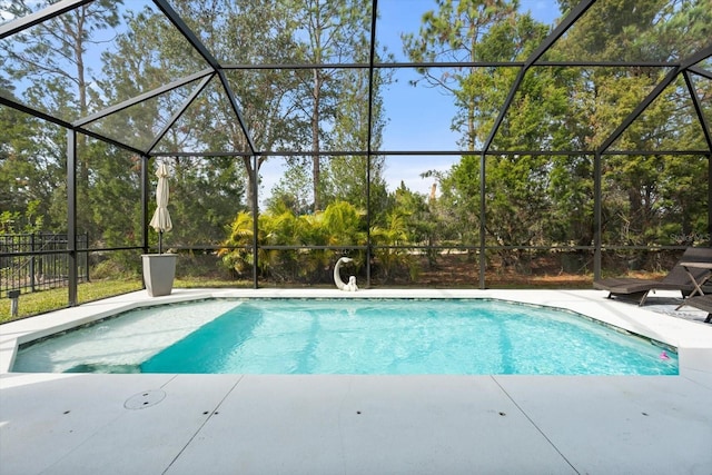 pool with a lanai and a patio area