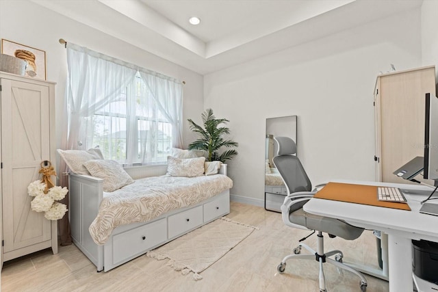 bedroom with light wood-style floors, baseboards, and recessed lighting