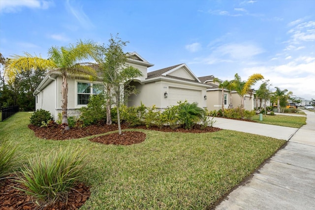 view of front of property featuring a garage and a front lawn