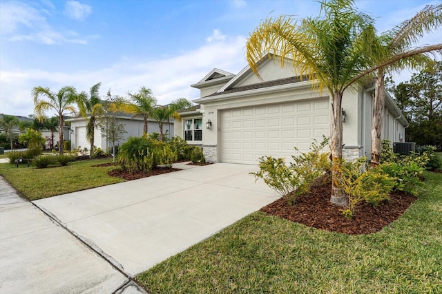 view of front of property featuring central air condition unit, a front yard, and a garage