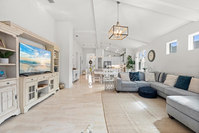 living room featuring lofted ceiling with beams, a healthy amount of sunlight, and an inviting chandelier