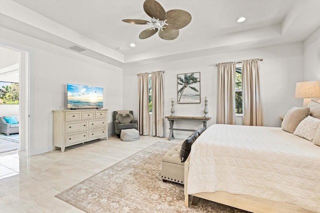 bedroom featuring access to exterior, a tray ceiling, visible vents, ceiling fan, and baseboards