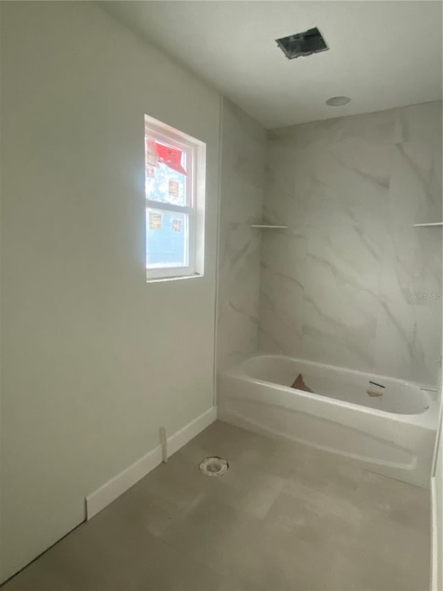 bathroom with shower / washtub combination