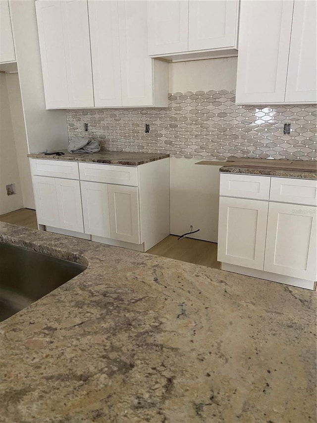 kitchen featuring white cabinetry and tasteful backsplash