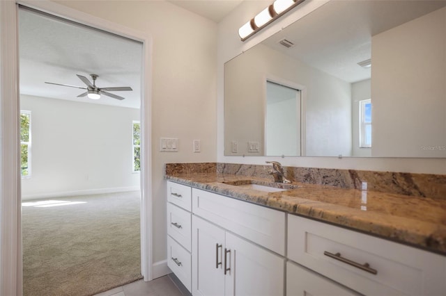 bathroom featuring a wealth of natural light, vanity, visible vents, and a ceiling fan