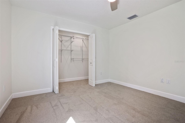 unfurnished bedroom with baseboards, a closet, visible vents, and carpet flooring