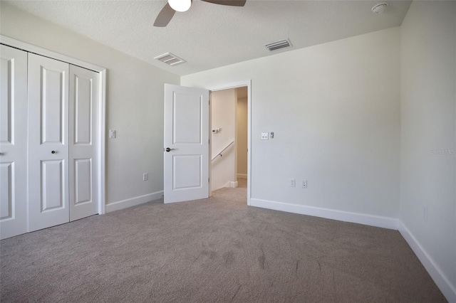 unfurnished bedroom with carpet floors, visible vents, and baseboards