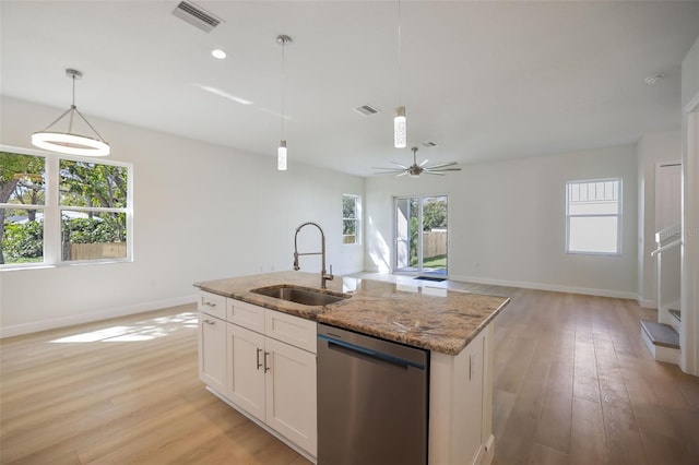 kitchen featuring dishwasher, light wood-style flooring, a sink, and visible vents