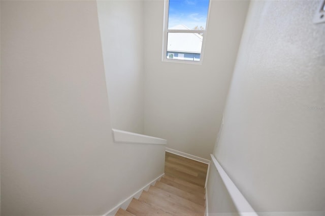 stairs featuring baseboards and wood finished floors