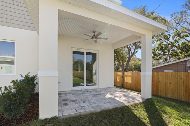 view of patio / terrace with ceiling fan and fence