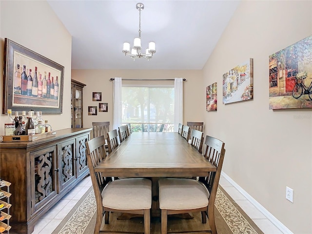 dining area featuring light tile patterned floors, lofted ceiling, and a notable chandelier