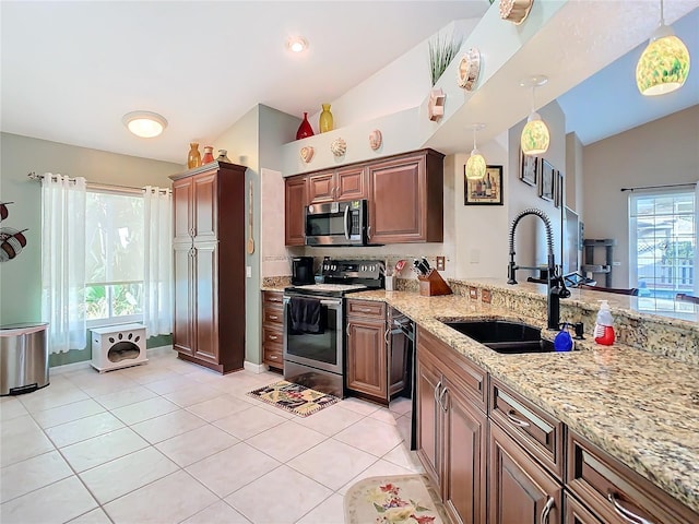 kitchen with appliances with stainless steel finishes, vaulted ceiling, sink, hanging light fixtures, and light tile patterned flooring