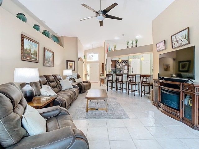 tiled living room with ceiling fan and lofted ceiling