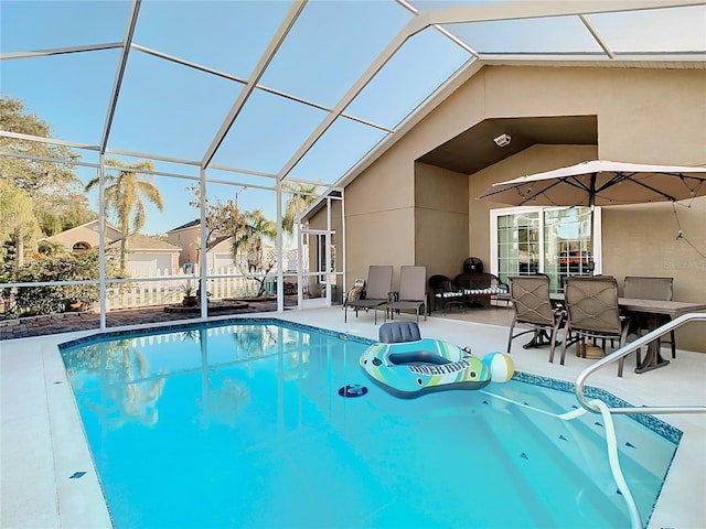 view of pool with a patio and glass enclosure