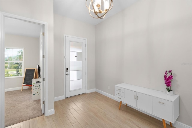 entryway featuring a chandelier and light hardwood / wood-style floors