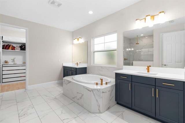 bathroom with vanity and separate shower and tub