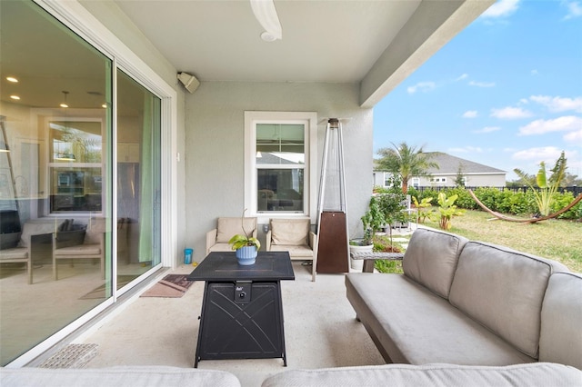 balcony featuring an outdoor living space, ceiling fan, and a patio