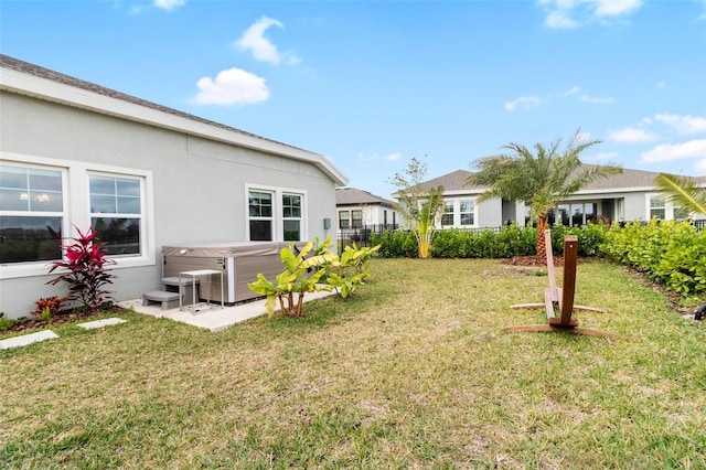 view of yard with central AC and a hot tub