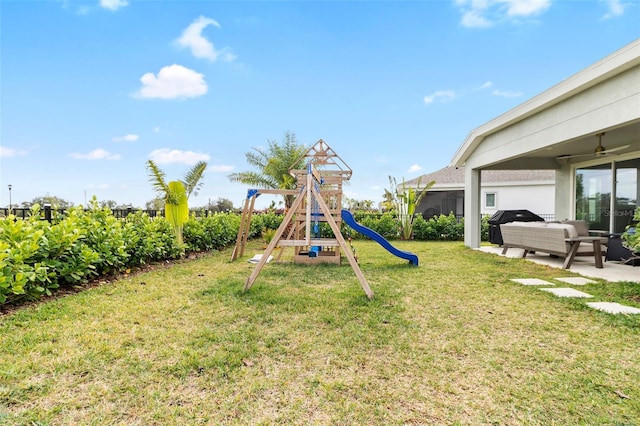 view of jungle gym featuring a patio area and a yard