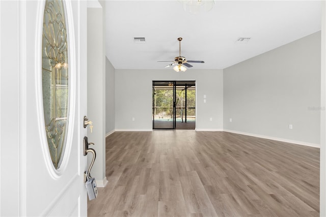 empty room featuring ceiling fan and light wood-type flooring