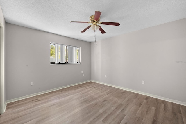 unfurnished room featuring ceiling fan, light hardwood / wood-style flooring, and a textured ceiling