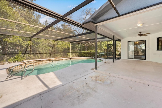 view of pool with glass enclosure, ceiling fan, and a patio area