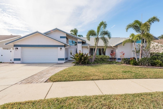 single story home featuring a front lawn and a garage