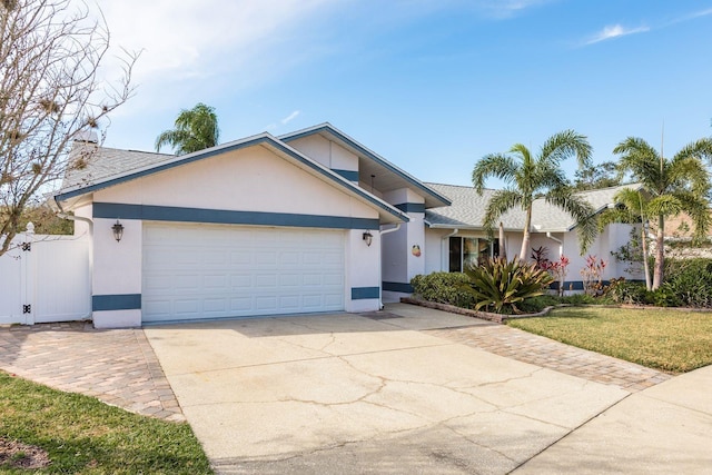 view of front of house with a front yard and a garage