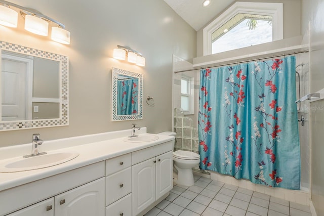 bathroom with vaulted ceiling, tile patterned flooring, vanity, toilet, and a shower with shower curtain