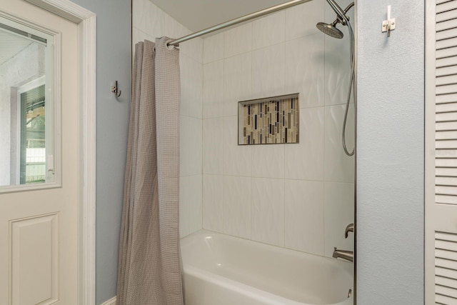 bathroom featuring shower / bathtub combination with curtain