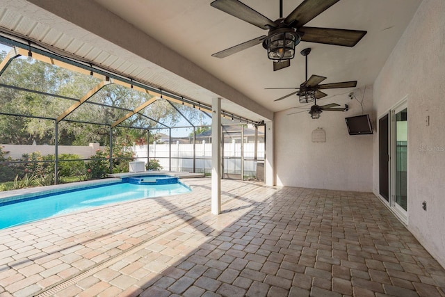 view of swimming pool with ceiling fan, glass enclosure, a patio area, and an in ground hot tub