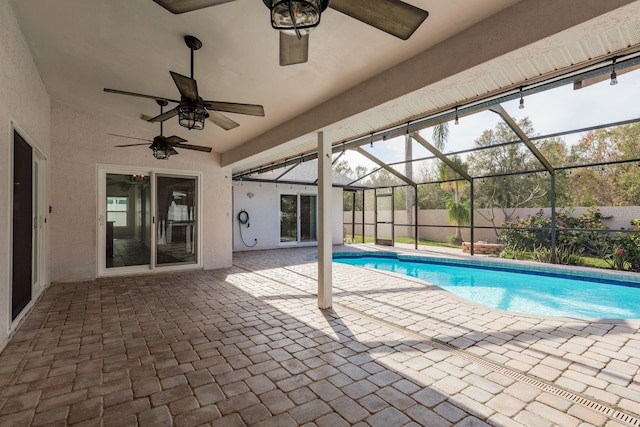 view of pool featuring a lanai, ceiling fan, and a patio area