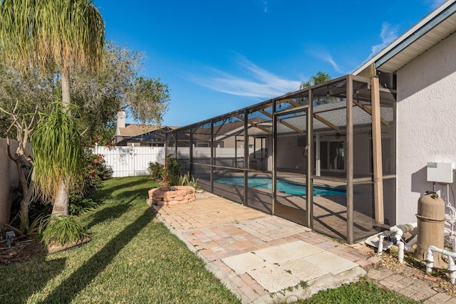 view of swimming pool featuring glass enclosure, a lawn, and a patio