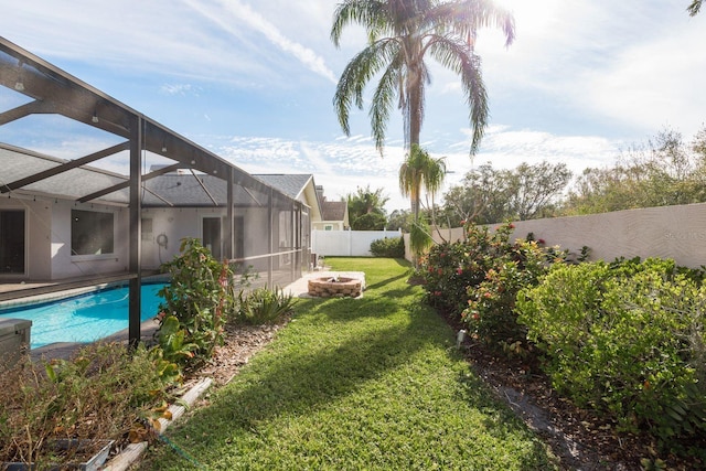 view of yard with a lanai and a fenced in pool