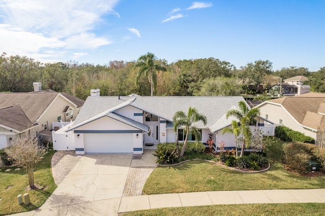 view of front of house with a garage and a front lawn