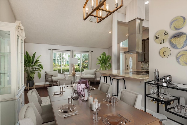 dining space featuring vaulted ceiling and hardwood / wood-style flooring