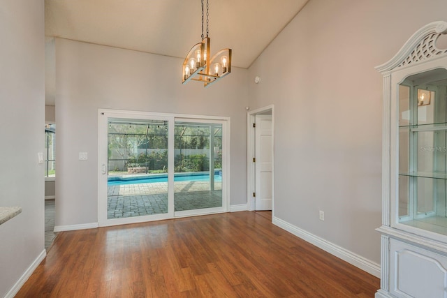 interior space featuring hardwood / wood-style floors and an inviting chandelier