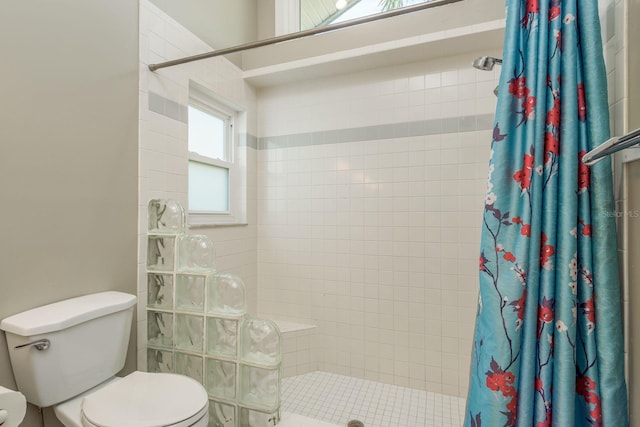 bathroom featuring toilet and a shower with shower curtain