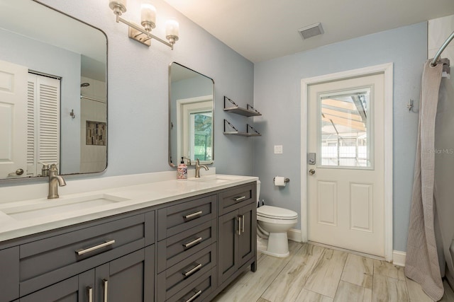 bathroom featuring toilet and vanity