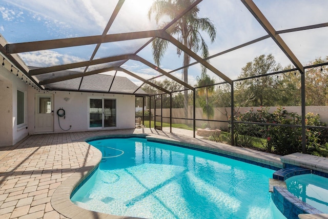 view of swimming pool with a lanai, an in ground hot tub, and a patio