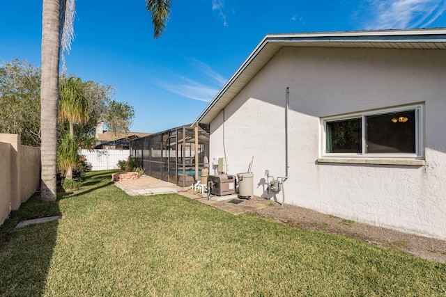 view of yard with a lanai, a patio area, and a fenced in pool